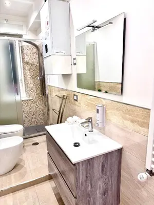 a bathroom with a sink and a toilet and a mirror at SUITE56Roma in Rome