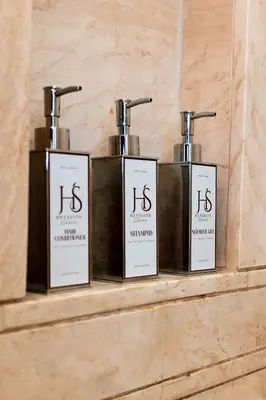 three bottles of soap sitting on a shelf at HeySuite Classic - Luxury House - Navona in Rome