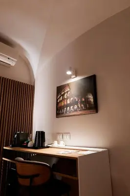 a room with a desk with a tv on the wall at HeySuite Classic - Luxury House - Navona in Rome