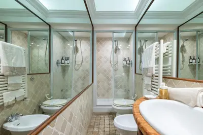 a bathroom with two toilets and a shower at NOSTROMONDO Prestigious 2 bedrooms Domus in Forum Area in Rome