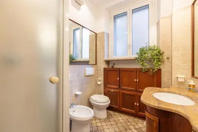 a bathroom with a toilet and a sink at NOSTROMONDO Prestigious 2 bedrooms Domus in Forum Area in Rome