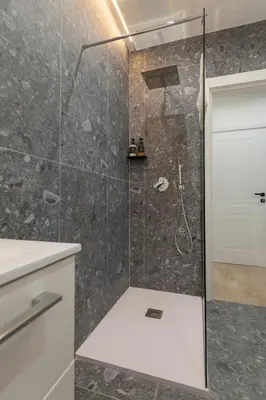 a shower with a glass door in a bathroom at Domus Boccea - Vatican Apartment in Rome