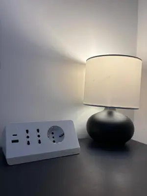a lamp sitting on a table next to a remote control at Domus Boccea - Vatican Apartment in Rome