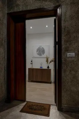 an open door to a room with a table at Domus Boccea - Vatican Apartment in Rome