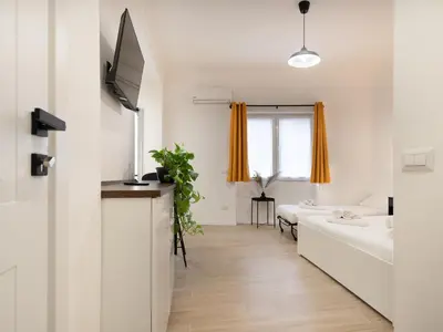 a white apartment with a living room and a couch at Domus Boccea - Vatican Apartment in Rome
