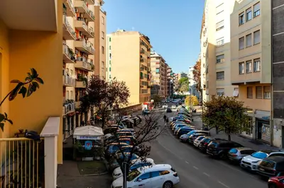 a city street with a row of parked cars at La casetta di Trastevere in Rome
