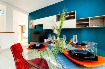a dining room with a glass table and red chairs at La casetta di Trastevere in Rome