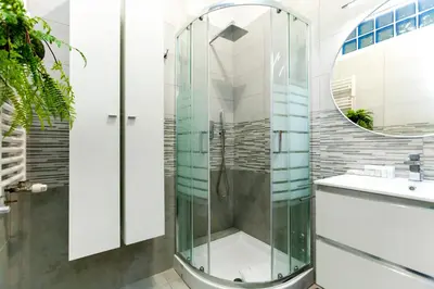 a glass shower in a bathroom with a sink at La casetta di Trastevere in Rome