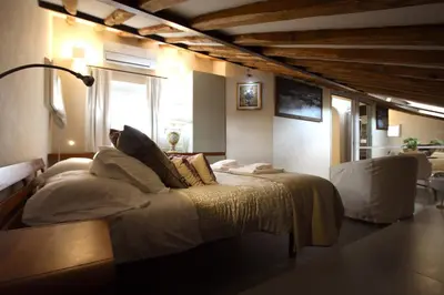 a bedroom with a bed with pillows on it at Il Nido sui Tetti di Piazza Navona in Rome