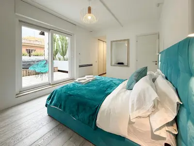 a large bed in a room with a large window at Vatican Luxury Duplex in Rome