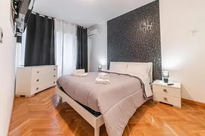 a bedroom with a bed and a large window at Desiré Flat - Vatican City - Metro Cipro and WiFi in Rome
