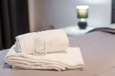 a pile of towels sitting on top of a table at Desiré Flat - Vatican City - Metro Cipro and WiFi in Rome