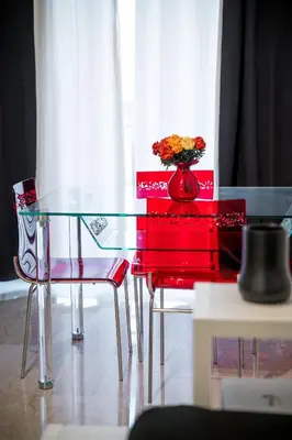 a glass table with a vase of flowers on it at Desiré Flat - Vatican City - Metro Cipro and WiFi in Rome