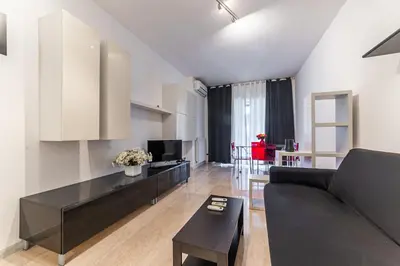a living room with a couch and a table at Desiré Flat - Vatican City - Metro Cipro and WiFi in Rome