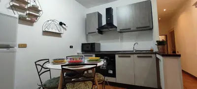 a small kitchen with a table and a sink at Auror house in Rome