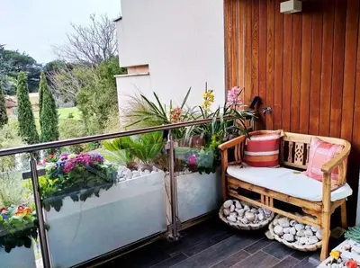 a balcony with a bench and some flowers and plants at Exceptional near Vatican flat with swimming pool in Rome