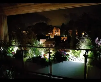 a view of a garden from a window at night at Exceptional near Vatican flat with swimming pool in Rome