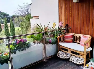 a porch with a bench on a balcony with flowers at Exceptional near Vatican flat with swimming pool in Rome