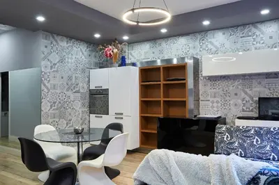 a kitchen and dining room with a table and chairs at Roma Vaticano Deluxe Apartment in Rome