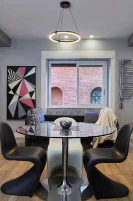 a dining room with a glass table and chairs at Roma Vaticano Deluxe Apartment in Rome