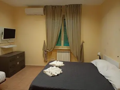 a bedroom with a bed with two towels on it at Gemelli House in Rome