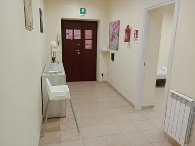 a bedroom with a bed and a desk with a monitor at Gemelli House in Rome