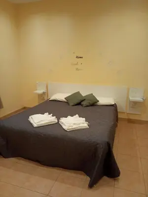 a bedroom with a bed with two towels on it at Gemelli House in Rome