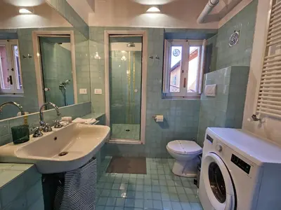 a bathroom with a sink and a washing machine at Be Your Home - CasAngelica in Rome