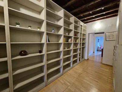 a wall of shelves in a room with a hallway at Be Your Home - CasAngelica in Rome