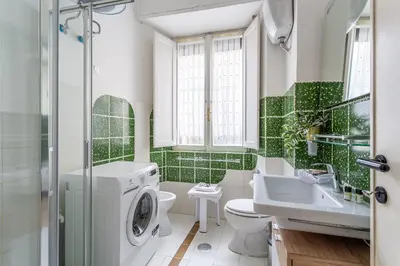 a bathroom with a washing machine and a sink at iFlat Colosseo Prestige in Rome