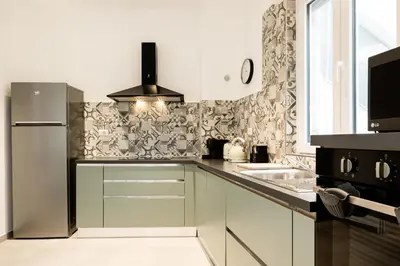 a kitchen with a refrigerator and a sink at Domus Solis in Rome