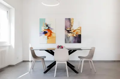 a dining room with a table and three paintings on the wall at Domus Solis in Rome