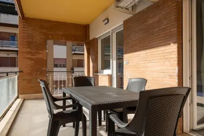 a black table and chairs on a balcony at Domus Solis in Rome