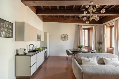 a kitchen and living room with a couch and a table at iFlat Trastevere Life with Beauty, Elegance & SPA in Rome