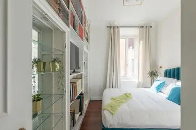 a bedroom with a bed and a book shelf at iFlat Trastevere Life with Beauty, Elegance & SPA in Rome