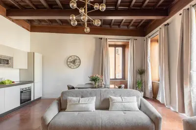 a living room with a couch and a chandelier at iFlat Trastevere Life with Beauty, Elegance & SPA in Rome
