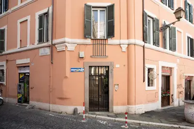 a peach colored building on a street at iFlat Trastevere Life with Beauty, Elegance & SPA in Rome