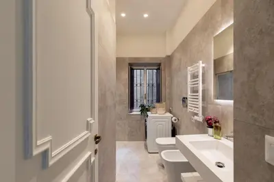 a bathroom with two toilets and a sink at iFlat Trastevere Life with Beauty, Elegance & SPA in Rome