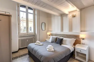 a bedroom with a large bed with towels on it at Napoleone 2 bedroom apartment in Rome