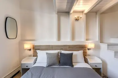 a bedroom with a large bed with two night stands at Napoleone 2 bedroom apartment in Rome
