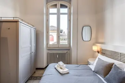 a bedroom with a large bed with a window at Napoleone 2 bedroom apartment in Rome
