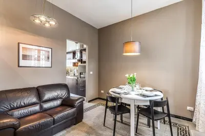 a living room with a couch and a table at Napoleone 2 bedroom apartment in Rome