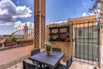 a table and chairs on a balcony with a view at Napoleone 2 bedroom apartment in Rome