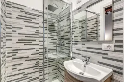 a bathroom with a sink and a shower at Monti Studio Roman Forum in Rome