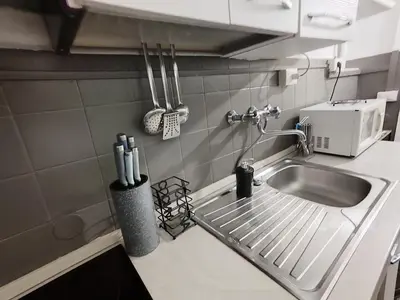 a kitchen counter with a sink and a microwave at Monti Studio Roman Forum in Rome