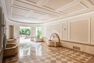 a large room with a coffered ceiling and a checkered floor at Vittorio Emanuele Grand Apartment in Rome