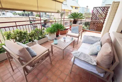 a patio with a couch and chairs on a balcony at Il Punto in Rome