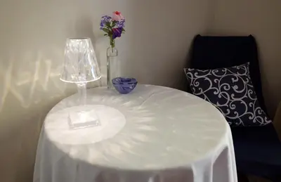 a white table with a vase of flowers on it at Il Punto in Rome