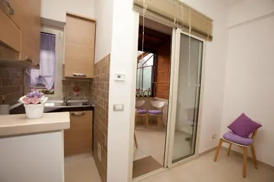 a kitchen with a glass door leading to a bathroom at Il Punto in Rome