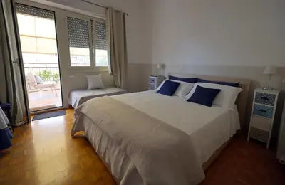 a bedroom with a large bed with blue pillows at Il Punto in Rome